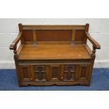 AN OLD CHARM OAK HALL SETTLE, with a hinged storage compartment, width 100cm x depth 52cm x height