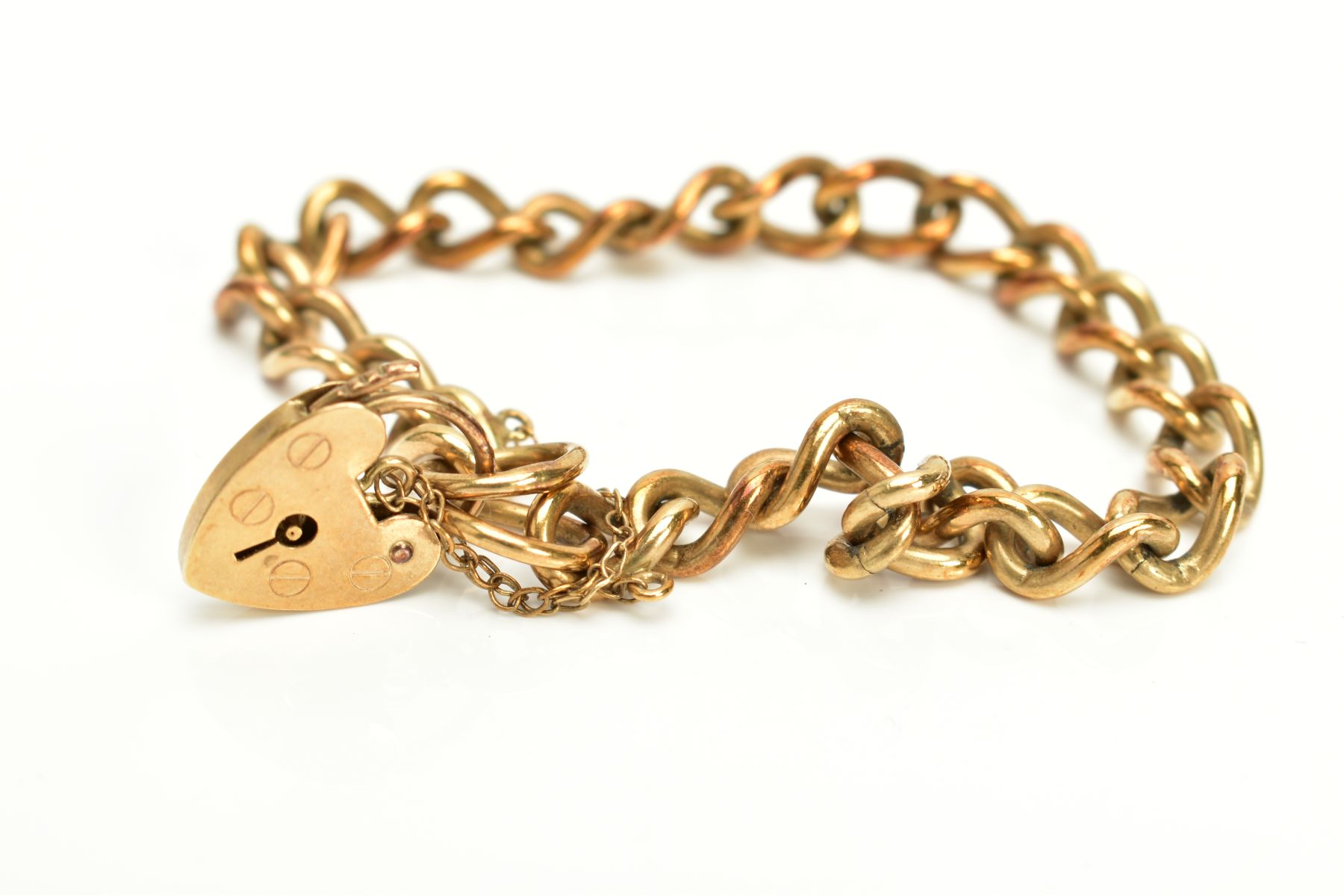 A 9CT GOLD HEAVY CHARM BRACELET, of curb link design hallmarked 9ct gold London import, fitted