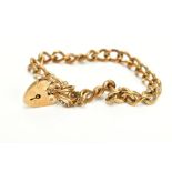 A 9CT GOLD HEAVY CHARM BRACELET, of curb link design hallmarked 9ct gold London import, fitted