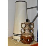 A 1970'S BROWN AND CREAM GLAZED TWIN HANDLED POTTERY TABLE LAMP, with conical fabric shade, height