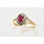 A 9CT GOLD RUBY AND DIAMOND CLUSTER RING, the raised cluster designed with a claw set oval cut ruby,