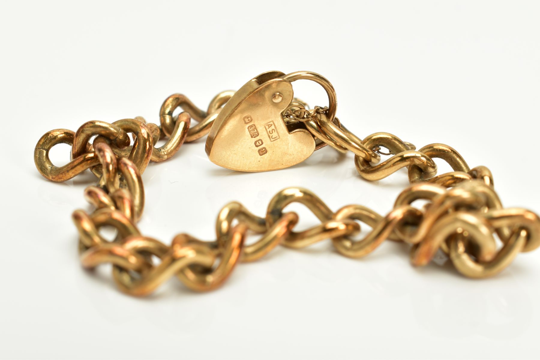 A 9CT GOLD HEAVY CHARM BRACELET, of curb link design hallmarked 9ct gold London import, fitted - Image 3 of 3