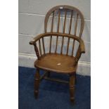 A 20TH CENTURY OAK AND ELM CHILDS WINDSOR ARMCHAIR, on turned legs united by a H stretcher