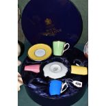 A BOXED ROYAL WORCESTER HARLEQUIN SET OF FOUR COFFEE CUPS AND SAUCERS, bears backstamp 'In