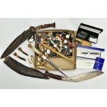 A SELECTION OF ITEMS, to include two Kukri swords with sheaths, one with smaller blades, a