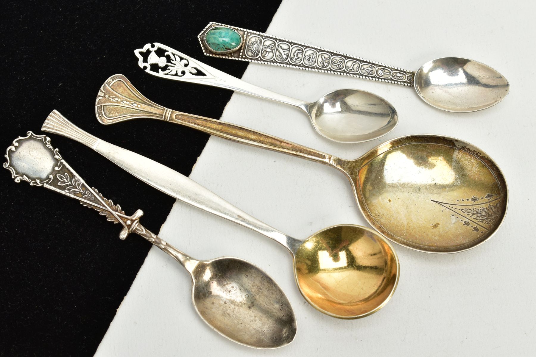 A SMALL PARCEL OF SILVER/WHITE METAL SPOONS, to include a foliate engraved soup spoon, hallmarked