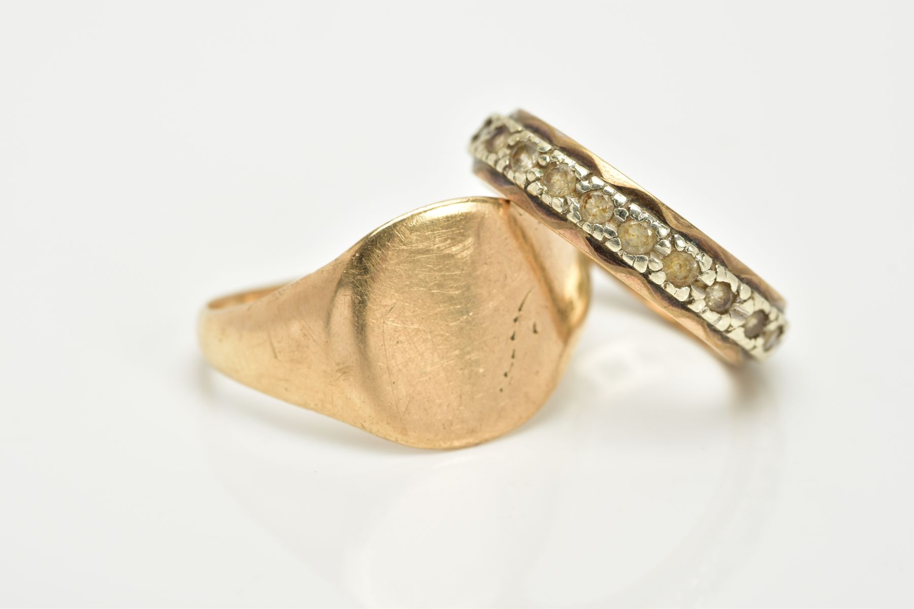 A GENTS SIGNET RING AND A FULL ETERNITY RING, the yellow metal gents signet ring, with a rubbed