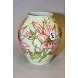 A MOORCROFT POTTERY COLLECTORS CLUB VASE, pale green ground decorated with pink lilies, impressed