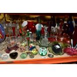 A GROUP OF GLASSWARE INCLUDING COLOURED ITEMS, two ships in bottles, various modern paperweights,