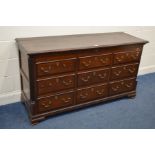 A GEORGE III OAK AND MAHOGANY CROSSBANDED MULE CHEST, with six dummy drawers above three drawers,