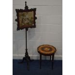 A VICTORIAN MAHOGANY CARVED NEELDLEWORK POLE SCREEN, on a cylindrical support on tripod legs