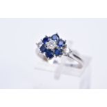 AN 18CT WHITE GOLD DIAMOND AND SAPPHIRE CLUSTER RING, the raised cluster designed with a central