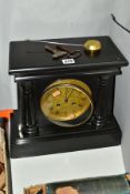 A LATE VICTORIAN BLACK SLATE MANTEL CLOCK, the moulded pediment supported on two half columns with