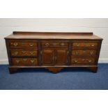 AN 18TH CENTURY OAK DRESSER BASE raised back behind a double plank top and moulded edges