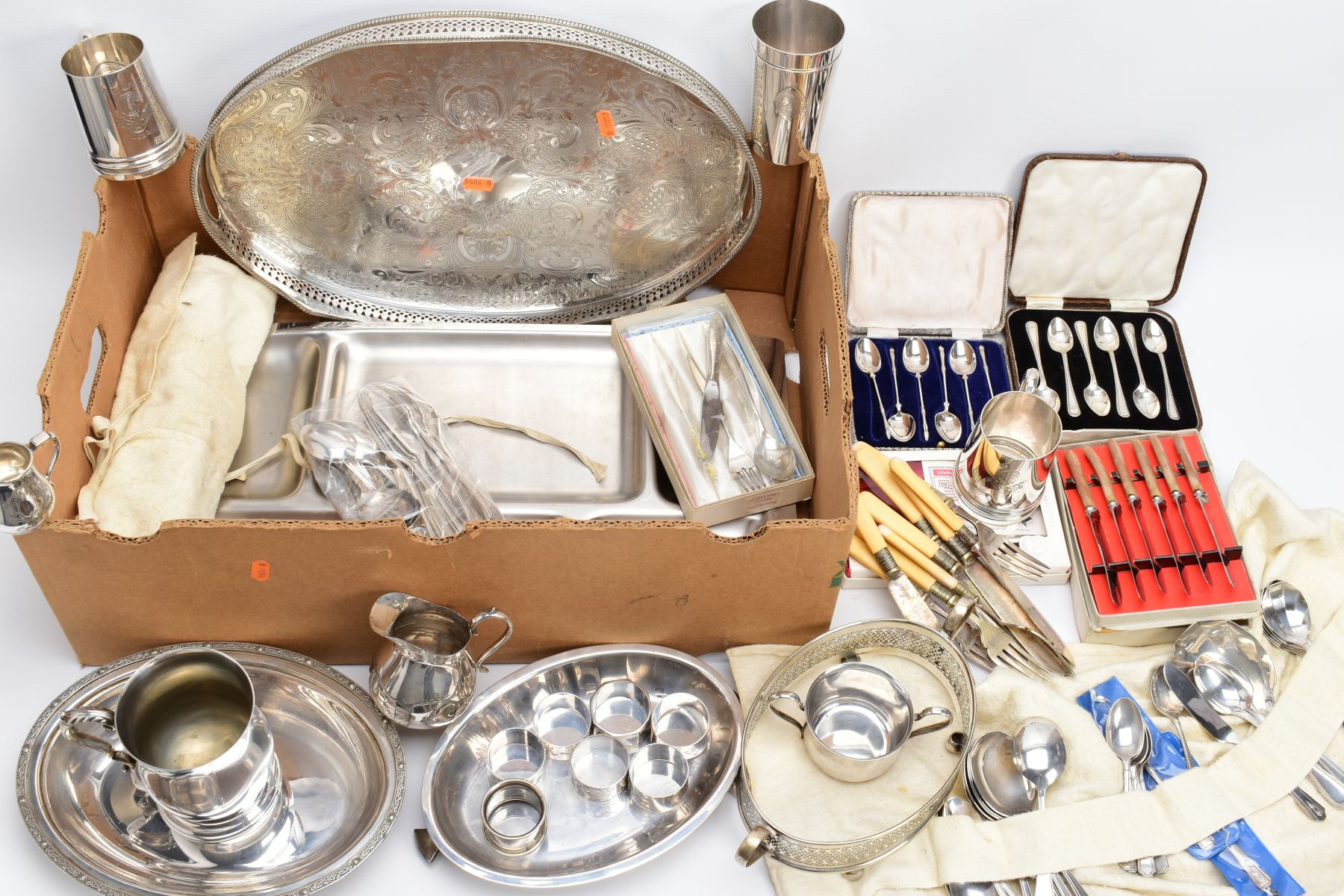 A BOX OF METALWARE, to include a silver plated on copper oval foliate engraved tray, two 'Walker &