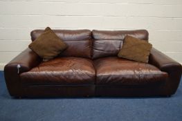 A BROWN LEATHER TWO SEATER SETTEE with two cushions width 240cm x depth 100cm