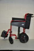 A DAYS ESCAPE FOLDING WHEEL CHAIR in red with two footrests