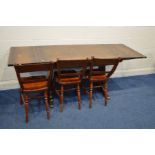 A MID 20TH CENTURY OAK DRAW LEAF DINING TABLE and three stained beech chairs (4)