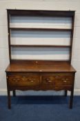 AN 18TH CENTURY OAK DRESSER the shelved top above two deep freize drawers including one silver