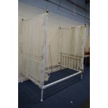 A VICTORIAN WHITE PAINTED CAST IRON AND BRASS 4'6'' FULL TESTER BED FRAME with distressed drapes