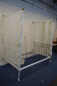 A VICTORIAN WHITE PAINTED CAST IRON AND BRASS 4'6'' FULL TESTER BED FRAME with distressed drapes