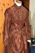 A SECOND HALF 19TH CENTURY BROWN SILK TWO PIECE DAY DRESS, with fringing and pleats to the bodice