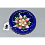 A MOORCROFT POTTERY LIPPED BOWL, the centre of the interior with a Columbine on a blue ground,