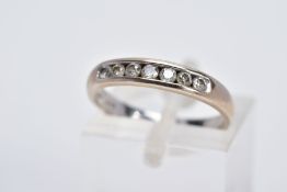 AN 18CT WHITE GOLD DIAMOND HALF ETERNITY RING, designed with a row of seven channel set round