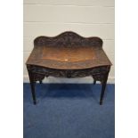 A LATE 19TH/EARLY 20TH CENTURY CARVED OAK SIDE TABLE with foliate decoration raised back and