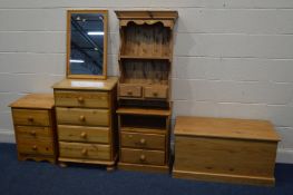 A QUANTITY OF PINE FURNITURE to include a tall chest of four drawers two pine bedside cabinets