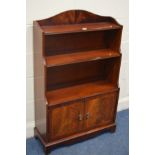 A MODERN MAHOGANY WATERFALL OPEN BOOKCASE with double cupboard doors width 74cm x depth 28cm x
