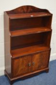 A MODERN MAHOGANY WATERFALL OPEN BOOKCASE with double cupboard doors width 74cm x depth 28cm x