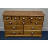 A MODERN PINE SIDEBOARD/CHEST OF TWELVE ASSORTED DRAWERS width 117cm x depth 39cm x height 76cm