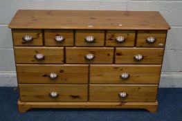 A MODERN PINE SIDEBOARD/CHEST OF TWELVE ASSORTED DRAWERS width 117cm x depth 39cm x height 76cm