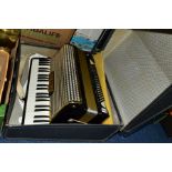 A HOHNER ARIETTA IVM ACCORDION, black and gold coloured finish, in a hard carry case