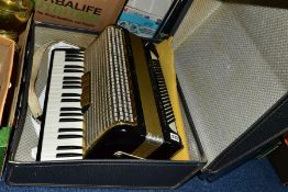 A HOHNER ARIETTA IVM ACCORDION, black and gold coloured finish, in a hard carry case