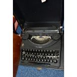 A CASED OLIVER PORTABLE TYPEWRITER, a plywood doll's crib containing a plastic Tiny Tears type doll,