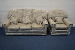 A FLORAL UPHOLSTERED TWO PIECE LOUNGE SUITE comprising a three seater settee and an armchair (2)