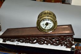 A LATE 19TH/EARLY 20TH CENTURY BRASS CASED ROLLING CLOCK, the 7.5cm enamel dial with swag decoration