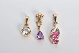 THREE YELLOW METAL GEM SET PENDANTS, the first a drop set with two circular cut pink sapphires