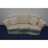 A CREAM UPHOLSTERED CONCAVE THREE SEATER SETTEE 205cm