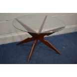 A MID TO LATE 20TH CENTURY TEAK CIRCULAR GLASS TOP COFFEE TABLE on an X frame diameter 77cm x height