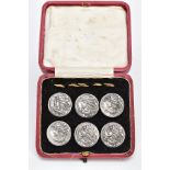 A CASED SET OF SIX EDWARDIAN SILVER BUTTONS, each one embossed depicting a lady in profile, with