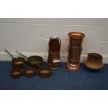 A SET OF FIVE GRADUATING COPPER PANS with iron hooped handles together with three various copper
