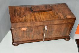 AN EARLY VICTORIAN MAHOGANY TEA CADDY OF SARCOPHAGUS FORM, the hinged cover opening to reveal two