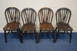 A SET OF FOUR EARLY TO MID 20TH CENTURY STAINED OAK AND BEECH SPINDLE BACK KITCHEN CHAIRS