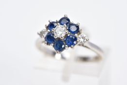 AN 18CT WHITE GOLD DIAMOND AND SAPPHIRE CLUSTER RING, the raised cluster designed with a central