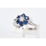 AN 18CT WHITE GOLD DIAMOND AND SAPPHIRE CLUSTER RING, the raised cluster designed with a central
