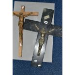 TWO FIRST HALF 20TH CENTURY WALL HANGING CRUCIFIXES, one of pale oak construction with patinated