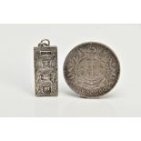 A SILVER INGOT PENDANT AND A COIN, the ingot decorated with a foliate design hallmarked Birmingham